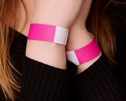 Neon pink paper wristbands